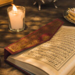 Home opened quran near candle sweet dates